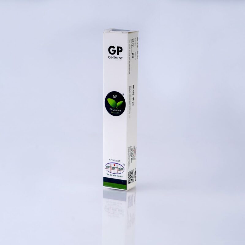 A white box with a green leaf on top sits on a white surface. Text on the box reads "GP Ointment" and "The Diet Hub". The box also includes Net quantity information.